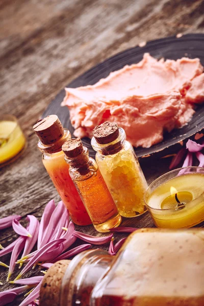 Bottles with sea salt and scrub for body — Stock Photo, Image