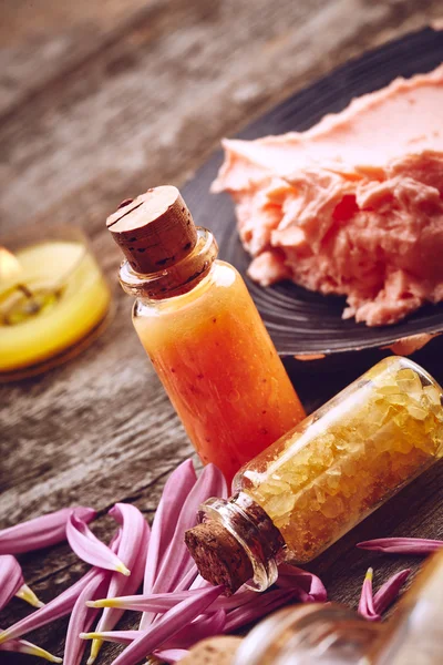 Bottles with sea salt and scrub for body — Stock Photo, Image