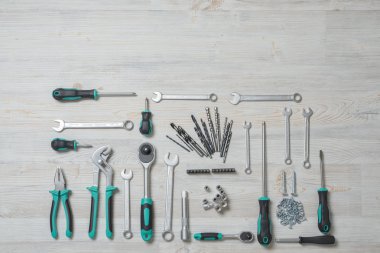Top view of construction instruments and tools on wooden DIY workbench with copy space at top