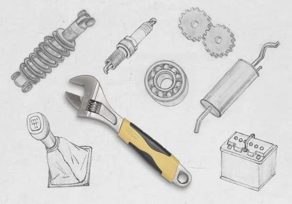Realistic yellow wrench on a concrete wall among drawing auto parts — Stok fotoğraf