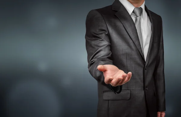 Businessman stretches out his right hand