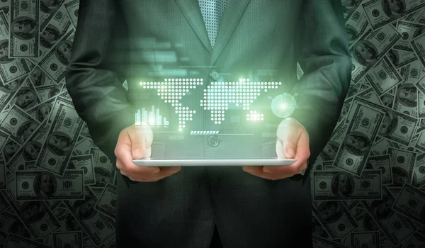 Businessman holding tablet pc computer with projection screen of graphic world map representation