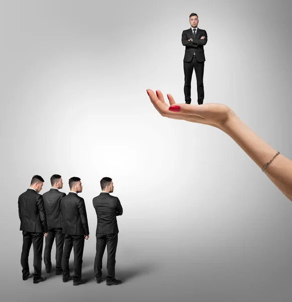 Male group stand under the other man which is on an increased hand of woman — Stock Photo, Image