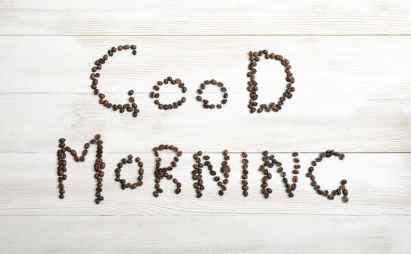 Top view of coffee beans making phrase Good morning