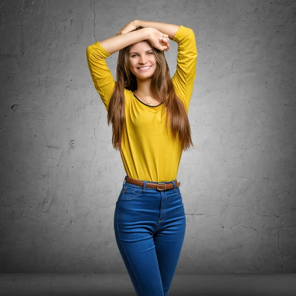 Cheerful young woman folded arms over her head