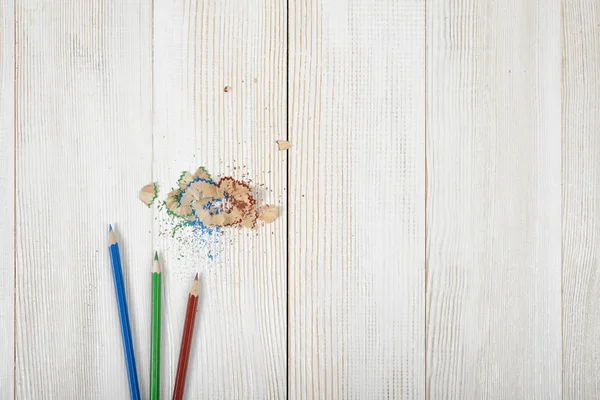 나무 판자에 그것의 부스러기와 녹색 및 파랑 색된 연필 — 스톡 사진