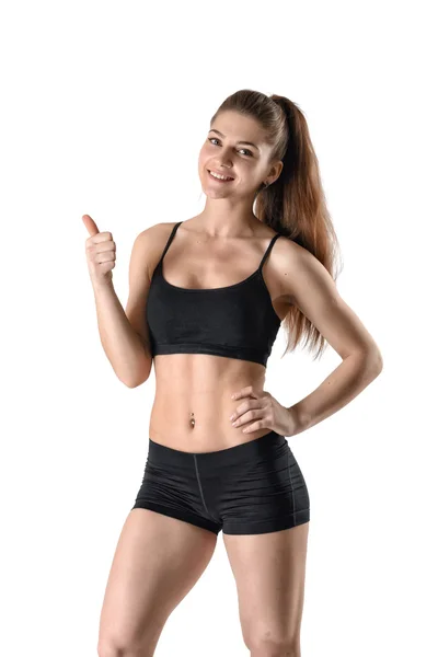 Femme de fitness souriante en short et un débardeur montre pouces vers le haut — Photo