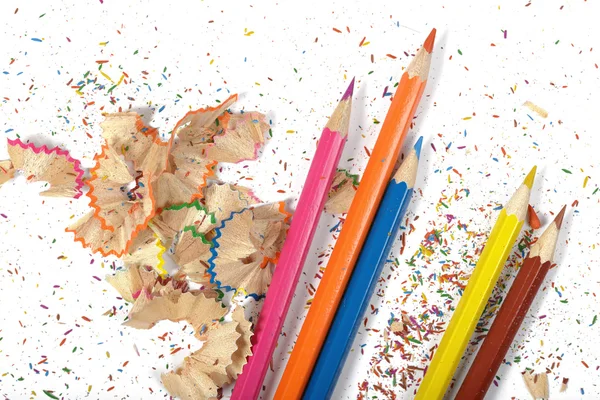 Flat lay of different colored pencils and shavings on table — Stock Photo, Image