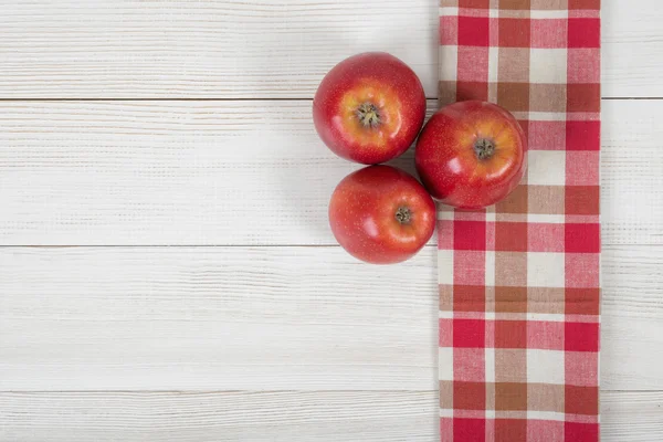 Appels geplaatst op rode geruite keuken tafellaken. Bovenaanzicht. Rechtenvrije Stockafbeeldingen