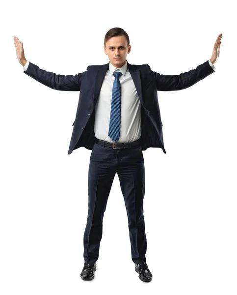 Businessman stands pushing invisible walls by his hands. Cutout portrait. — Stock Photo, Image