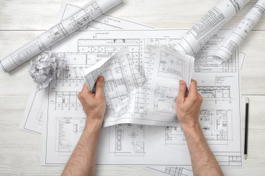 Close-up hands of architect tearing a bad drawing clipart