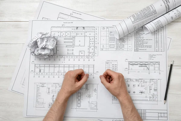 Close-up hands of architect working with a drawing