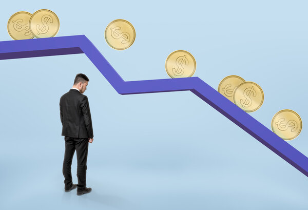 Businessman standing under falling graph with golden coins rolling down