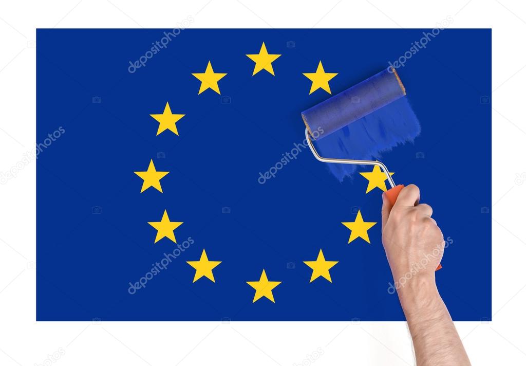 Close up view of mans hand painting over star on Europe Union flag