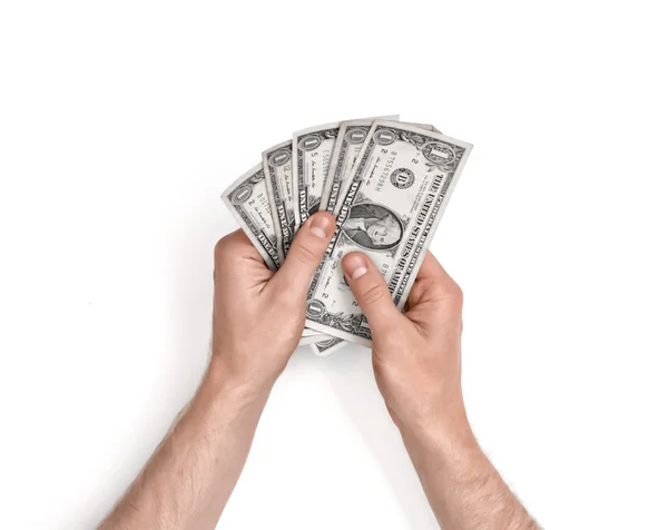Mãos de homem segurando notas de um dólar no fundo branco . — Fotografia de Stock