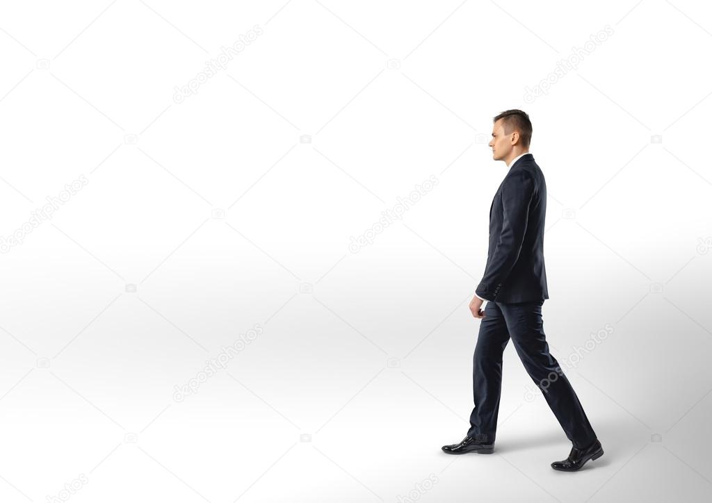 Side view of businessman walk, isolated on white background