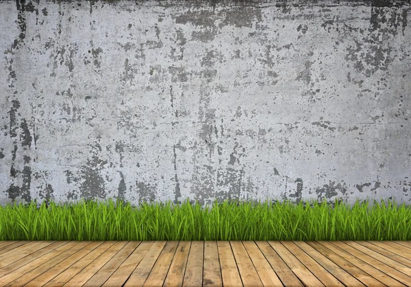 Achtergrond. Betonnen muur en houten vloer met gras — Stockfoto