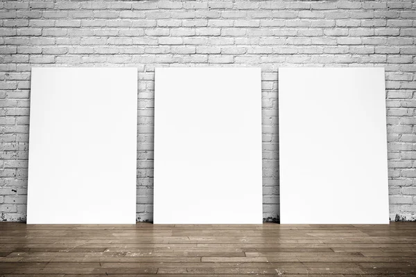 White posters on brick wall and wood floor — Stock Photo, Image