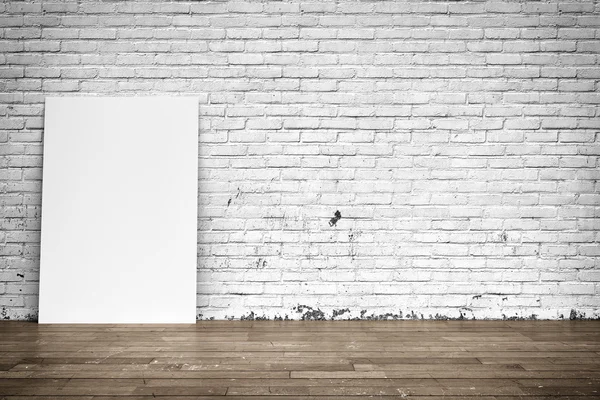 White poster on brick wall and wood floor — Stock Photo, Image