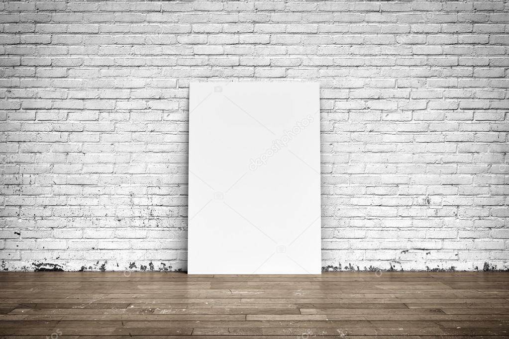 White poster on brick wall and wood floor