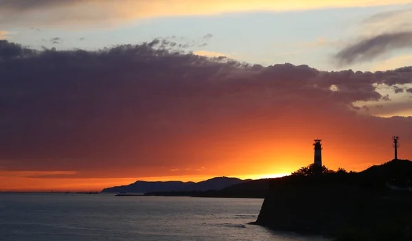 Beautiful sunset in the evening with clouds over the sea