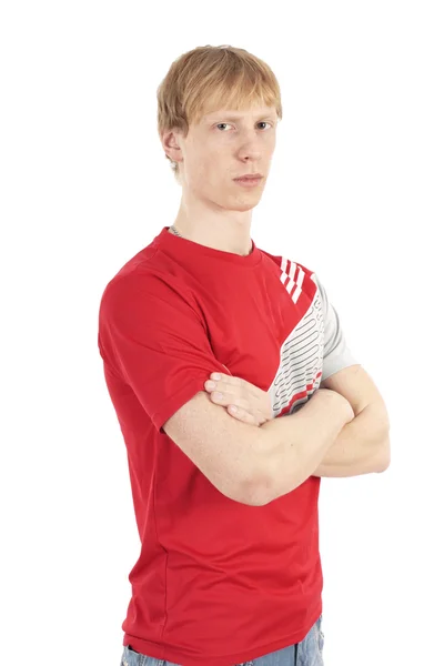 Attractive blond young serious man in red on a white background thinking — Stock Photo, Image