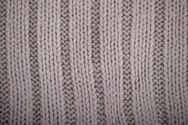 Detalj av virkade grå struktur från en tröja gjord av ull — Stockfoto