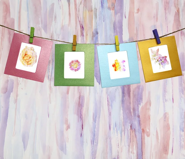 Beautiful watercolor flowers within a clothes pegs on an abstrac — Stock Photo, Image