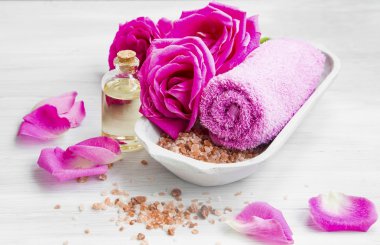 Spa setting with roses ,bath salt and oil, cotton towel 