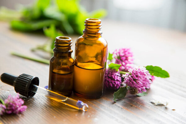 Alternative medicine, healing herbs oils, herbal aromatherapy oils with medicinal plants and herbs, essential oils bottles