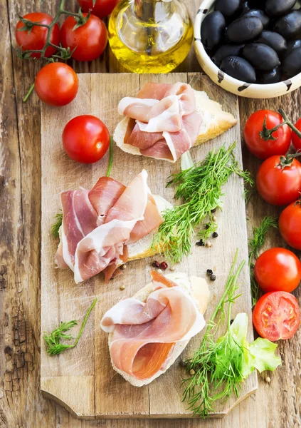 Prosciutto Ham Appetizer with Spices on a Wooden Cutting Board — Stock Photo, Image