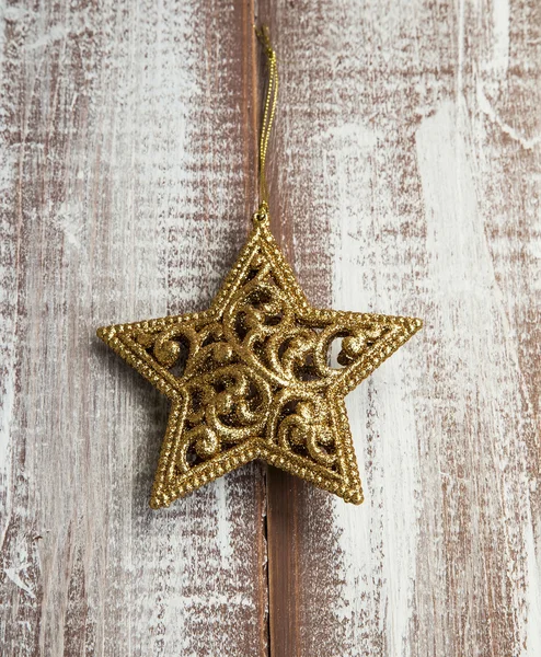 Golden Glitter Star Christmas Ornament on Wooden Painted Table — Stock Photo, Image