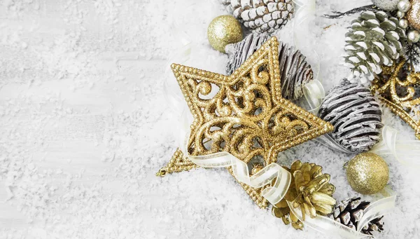 Golden Shiny Christmas Decorations in the Snow with Elegant Ribb — Stock Photo, Image