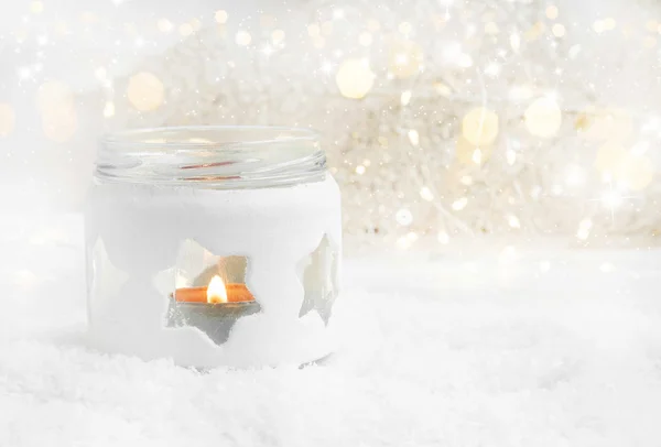 Christmas Candle in the Snow with Lights and Sparkle — Stock Photo, Image