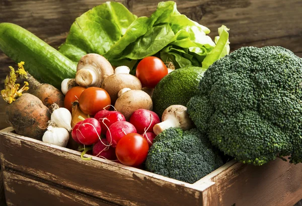 Bio vegetables in wooden crate with radish,salad,mushrooms,brocc — Stock Photo, Image