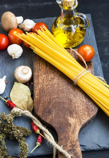 Italian meal ingredients with pasta,spices,tomatoes,olive oil on — Stock Photo, Image