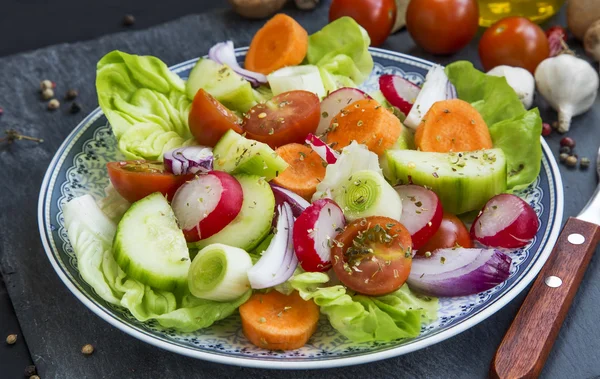 Verse salade met radijs, uien, tomaten, sla, wortel, komkommer een — Stockfoto