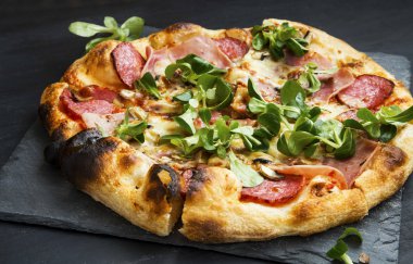 Pizza salam, peynir ve cornsalad yaprakları ile jambon