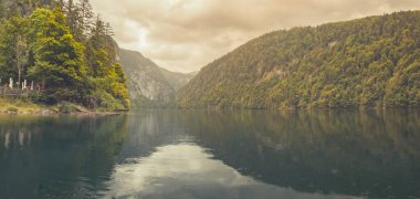 Dağ gölü, dinginlik gölünde sabah sisi. Dağ sırasının önündeki dağ gölünün panoramik manzarası, ulusal park, rüya doğa manzarası, sakin göl yansıması, çevrendeki yeşil orman, muhteşem dağ geçidi.. 