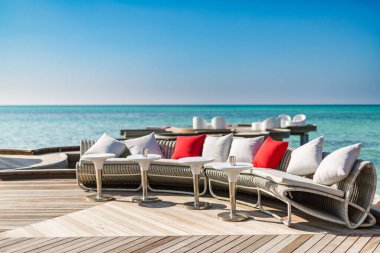 Chill lounge zone in luxury hotel on the shore of Indian Ocean. Tropical Maldives island, chill zone, over water lounge area. Luxury resort background