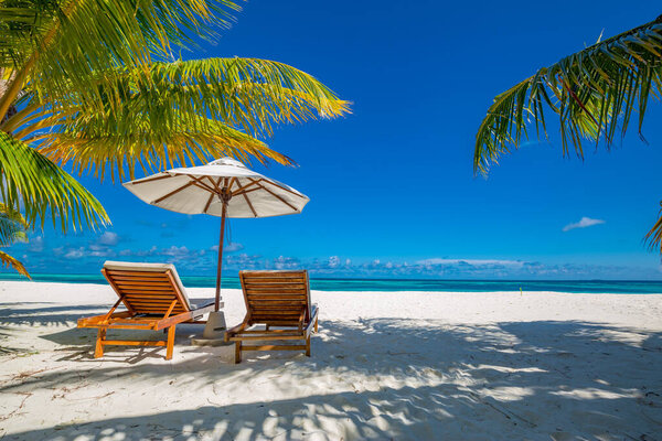 Beautiful beach. Chairs on the sandy beach near the sea. Summer holiday and vacation concept for tourism. Inspirational tropical landscape. Tranquil beach scene. Exotic tropical beach resort