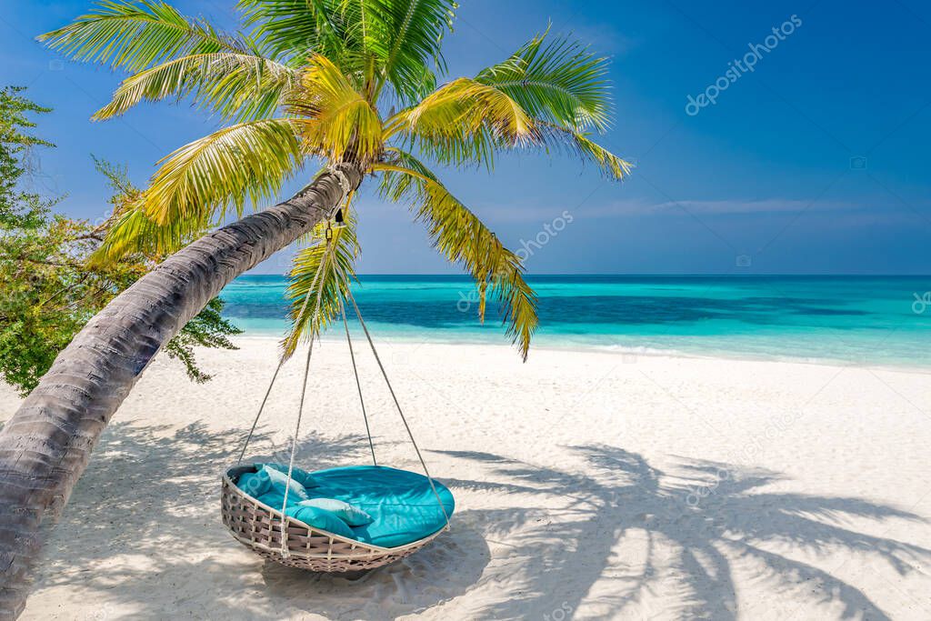 Tropical beach panorama as summer landscape with beach swing or hammock hanging on palm tree over white sand and calm sea for beach banner. Perfect beach scene vacation and summer holiday template. Luxury beach resort