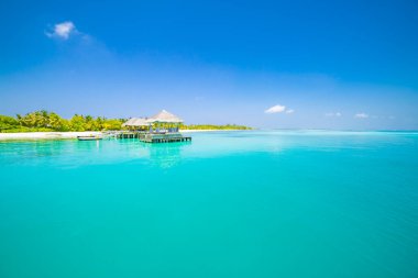 Güzel sahil ve tropikal deniz. Harika sahil doğası, Maldivler manzarası, egzotik manzarası, beyaz kum ve mavi gökyüzü. Yaz tatili ve tatil şablonu için lüks tatil beldesi geçmişi