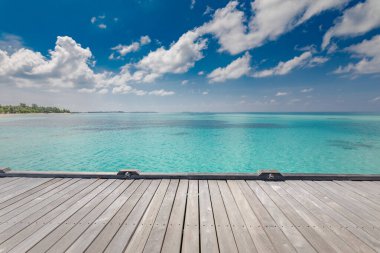 Empty top of wooden table or counter and view of tropical beach. For product display, over tropical beach view. Stunning blue sky clouds, summer moods, vibes.