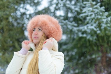 Winter attractive blond woman with beautiful makeup. Beauty portrait outdoors. Winter portrait of a beautiful blonde