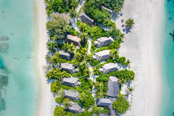 Summer aerial landscape, luxury tropical resort or hotel with beach villas bungalows and beautiful beach scenery. Amazing bird eyes view in Maldives, landscape seascape aerial view over a Maldives