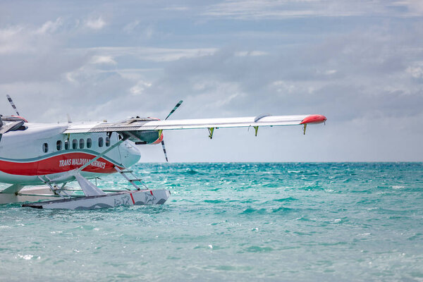 05.06.2018 - Ari Atoll, Maldives: Exotic scene with seaplane on Maldives sea landing. Vacation or holiday in Maldives concept background