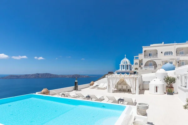 Luxury scenery with empty infinity pool Santorini. White architecture on Santorini island, Greece. Summer vacation, holiday concept. Amazing travel landscape, cityscape with blue sea view and famous white houses, swimming pool, luxurious resort hotel