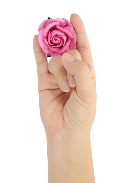 Künstliche rosa Rose in der Hand — Stockfoto