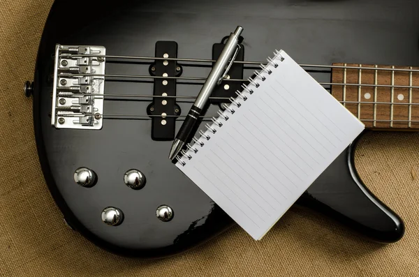 White paper on electric bass guitar — Stock Photo, Image